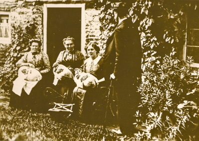 Lace makers working outside for the light